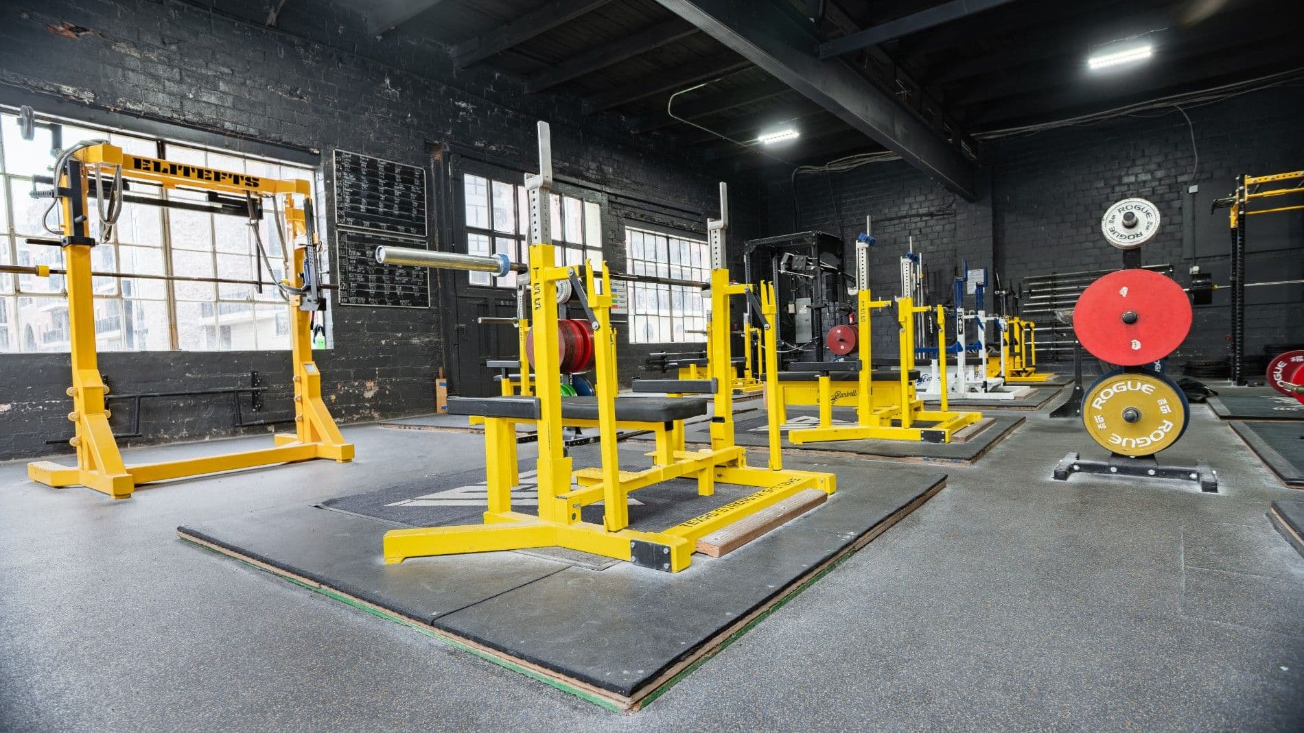 Competition platforms, calibrated plates, and lifting racks at Indy City Barbell gym